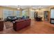 Spacious living room featuring hardwood floors, a built-in bookshelf and multiple seating areas at 20506 N 271St Ave, Buckeye, AZ 85396