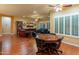 Bright living room featuring hardwood floors, a built-in bookshelf and multiple seating areas at 20506 N 271St Ave, Buckeye, AZ 85396