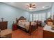 A traditional main bedroom with hardwood floors, plantation shutters and a ceiling fan at 20506 N 271St Ave, Buckeye, AZ 85396