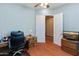Office space features hardwood floors and a view into another room through a double door, offering a bright and open workspace at 20506 N 271St Ave, Buckeye, AZ 85396
