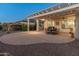 Covered outdoor patio with a large seating area, a built-in grill, a pergola and desert landscaping at 20506 N 271St Ave, Buckeye, AZ 85396