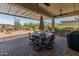 Inviting covered patio features comfortable seating, a built-in grill, and desert landscaping, perfect for outdoor entertaining at 20506 N 271St Ave, Buckeye, AZ 85396