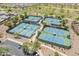Aerial view of well-maintained tennis and pickleball courts, offering a vibrant recreational amenity within the community at 20506 N 271St Ave, Buckeye, AZ 85396
