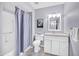 Bright bathroom featuring a shower with a gray curtain and a white vanity with a stone countertop at 21218 N Aurora Dr, Sun City West, AZ 85375