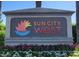 Landscaped community sign for Sun City West showcasing the vibrant colors and welcoming atmosphere of the neighborhood at 21218 N Aurora Dr, Sun City West, AZ 85375