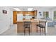 Well-lit kitchen with wooden cabinets, white appliances, and bar-style seating for casual dining at 21218 N Aurora Dr, Sun City West, AZ 85375
