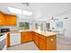 Bright kitchen features an island with barstool seating and flows into a dining area with sliding glass doors at 21218 N Aurora Dr, Sun City West, AZ 85375
