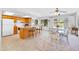 Bright kitchen with a breakfast bar that opens to the dining area and rear yard access at 21218 N Aurora Dr, Sun City West, AZ 85375