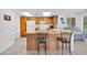 Open kitchen with skylights, breakfast bar, and modern appliances with access to a side patio at 21218 N Aurora Dr, Sun City West, AZ 85375