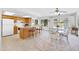 Open-concept kitchen featuring wooden cabinets, bar seating, and adjacent dining area with backyard views at 21218 N Aurora Dr, Sun City West, AZ 85375