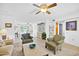 Bright and airy living room featuring tile flooring, ceiling fan, and an open concept at 21218 N Aurora Dr, Sun City West, AZ 85375