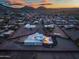Expansive aerial shot of the property highlighting the backyard pool, surrounding neighborhood, and mountain views at 2609 W Lavitt Ln, Phoenix, AZ 85086