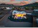 Stunning aerial view of the property at sunset, showcasing the pool, patio, and surrounding desert landscape at 2609 W Lavitt Ln, Phoenix, AZ 85086