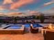 Inviting backyard with a pool, spa, outdoor seating, fire pit, and desert views at 2609 W Lavitt Ln, Phoenix, AZ 85086