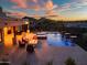 Stunning backyard featuring a pool with waterfalls, spa, outdoor seating, and mountain views at 2609 W Lavitt Ln, Phoenix, AZ 85086