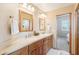 Beautiful primary bathroom with double vanity, wood cabinets, and framed mirrors at 2609 W Lavitt Ln, Phoenix, AZ 85086