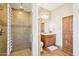 Elegant bathroom featuring a large shower, wood cabinets, and wood style flooring at 2609 W Lavitt Ln, Phoenix, AZ 85086