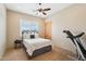 Bedroom featuring a queen bed, ceiling fan, and private ensuite at 2609 W Lavitt Ln, Phoenix, AZ 85086