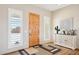 Welcoming foyer with a wooden front door and stylish décor, showcasing modern elegance at 2609 W Lavitt Ln, Phoenix, AZ 85086