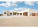 Beautiful desert home with a spacious driveway and three-car garage under a bright blue sky at 2609 W Lavitt Ln, Phoenix, AZ 85086