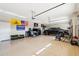 Well-organized three car garage with epoxy flooring and storage, ideal for car enthusiasts and hobbyists at 2609 W Lavitt Ln, Phoenix, AZ 85086