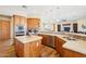 Well-designed kitchen with wood cabinets, stainless steel appliances, and a view into the living room at 2609 W Lavitt Ln, Phoenix, AZ 85086