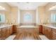 Bright bathroom with double vanities and a large soaking tub at 2609 W Lavitt Ln, Phoenix, AZ 85086