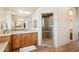 Bright bathroom with double vanities and a glass-enclosed shower at 2609 W Lavitt Ln, Phoenix, AZ 85086