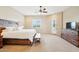 Spacious main bedroom featuring a king bed, ceiling fan, and access to the backyard at 2609 W Lavitt Ln, Phoenix, AZ 85086