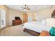 Spacious main bedroom featuring a king bed and access to the ensuite bathroom at 2609 W Lavitt Ln, Phoenix, AZ 85086