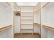 Walk-in closet with built-in shelving and hanging rods at 2609 W Lavitt Ln, Phoenix, AZ 85086