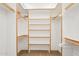 Walk-in closet with built-in shelving and hanging rods at 2609 W Lavitt Ln, Phoenix, AZ 85086
