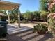 An outdoor patio area with desert landscaping and a pergola offering shaded outdoor living space at 2611 E San Paulo Dr, Casa Grande, AZ 85194