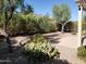 Landscaped backyard featuring desert plants and trees with beautiful xeriscaping and a covered patio at 2611 E San Paulo Dr, Casa Grande, AZ 85194
