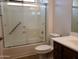Bathroom featuring a glass-enclosed shower, a sink vanity with drawers, toilet and hand rails at 2611 E San Paulo Dr, Casa Grande, AZ 85194