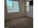 Bedroom with two windows offering outdoor views, carpeted floor, and mounted television at 2611 E San Paulo Dr, Casa Grande, AZ 85194
