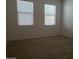 Bedroom with a neutral carpet, complemented by two windows for ample natural light at 2611 E San Paulo Dr, Casa Grande, AZ 85194