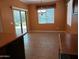 Open-concept dining area featuring neutral tile flooring and a sliding glass door to the backyard at 2611 E San Paulo Dr, Casa Grande, AZ 85194