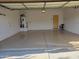 Open garage space featuring epoxy flooring, water heater, and interior door at 2611 E San Paulo Dr, Casa Grande, AZ 85194