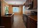 Well-lit kitchen with dark wood cabinetry, modern appliances, and tiled flooring at 2611 E San Paulo Dr, Casa Grande, AZ 85194