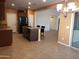 Spacious kitchen with an island, black appliances, and an open layout leading to the dining area at 2611 E San Paulo Dr, Casa Grande, AZ 85194