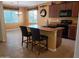 Bright kitchen featuring a central island with seating, modern appliances, and tiled flooring at 2611 E San Paulo Dr, Casa Grande, AZ 85194