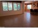 Open-concept living area with neutral tile flooring and large windows with decorative valances at 2611 E San Paulo Dr, Casa Grande, AZ 85194