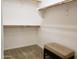 Walk-in closet featuring neutral-toned carpet, a bench, and shelving for maximum organization at 2611 E San Paulo Dr, Casa Grande, AZ 85194