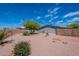Backyard features desert landscaping, a brick-lined patio, and block wall at 2807 W Gregory St, Apache Junction, AZ 85120
