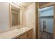 Bathroom with wood floor, light colored vanity and mirror plus an open closet at 2807 W Gregory St, Apache Junction, AZ 85120