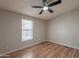 Bright bedroom with neutral walls, ceiling fan, and hardwood floors at 2807 W Gregory St, Apache Junction, AZ 85120