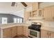 Bright kitchen featuring updated stainless steel gas range, countertops, and wood cabinetry at 2807 W Gregory St, Apache Junction, AZ 85120