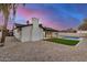 Inviting backyard featuring a pool, artificial grass, and charming architecture with a cozy covered patio at 2905 W Campo Bello Dr, Phoenix, AZ 85053