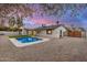 Spacious backyard with a sparkling pool, lush artificial grass, and tasteful design at 2905 W Campo Bello Dr, Phoenix, AZ 85053